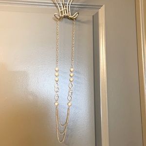 Long, layered silver and pearl necklace.